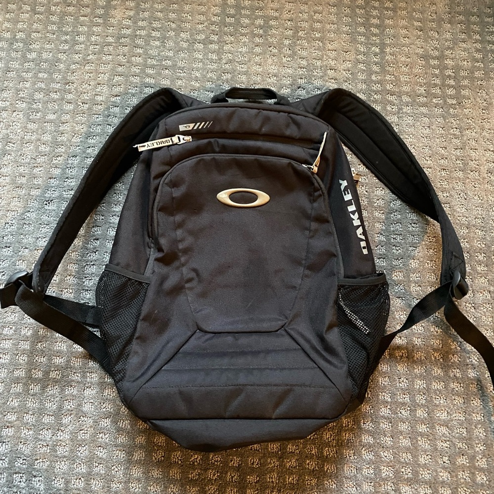 Oakley 19 H, 13 w, 5.5 deep base -sun glass, water bottle and laptop pockets.
